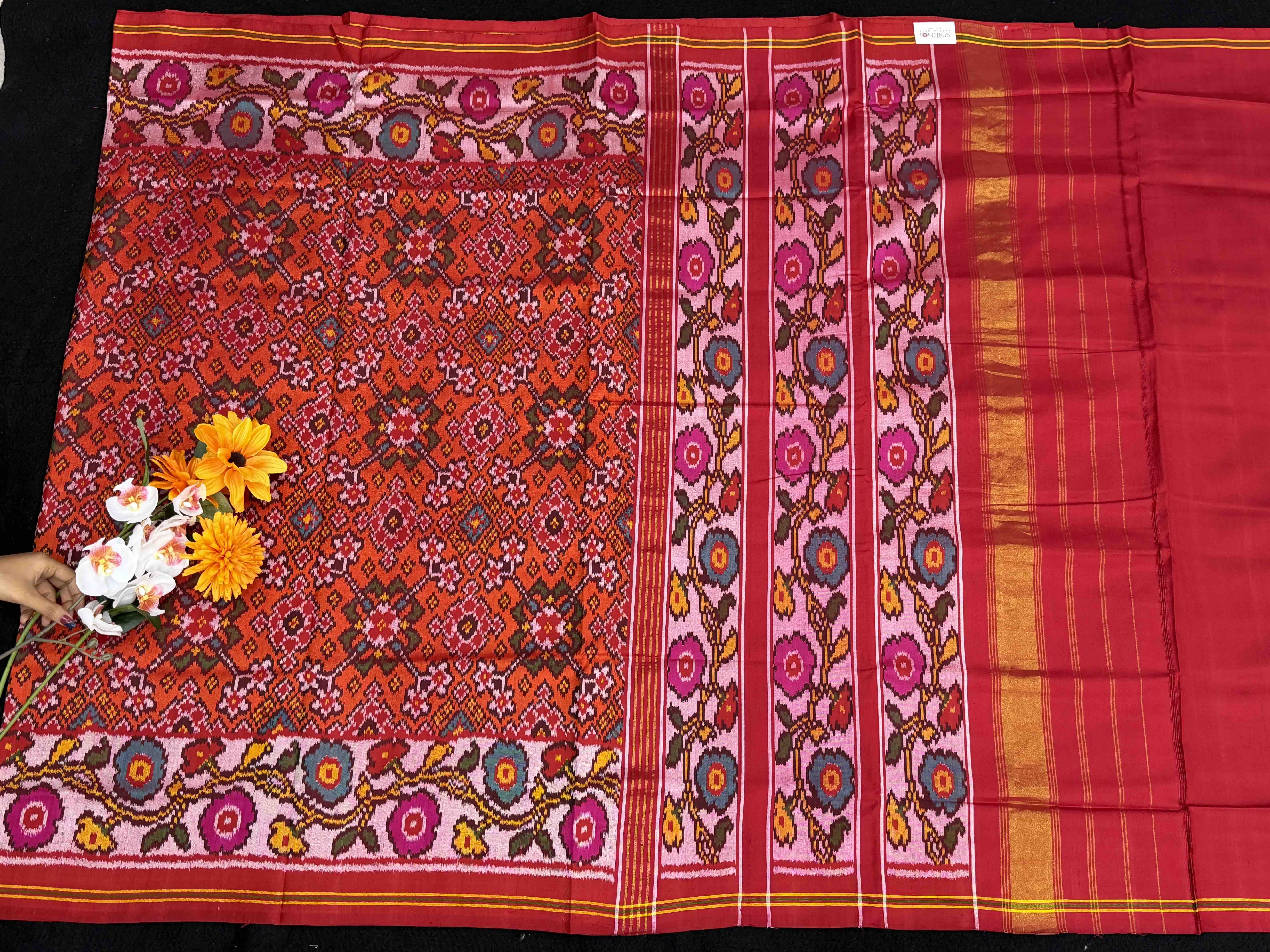 Offwhite Flowers border with orange red Navaratn Patola