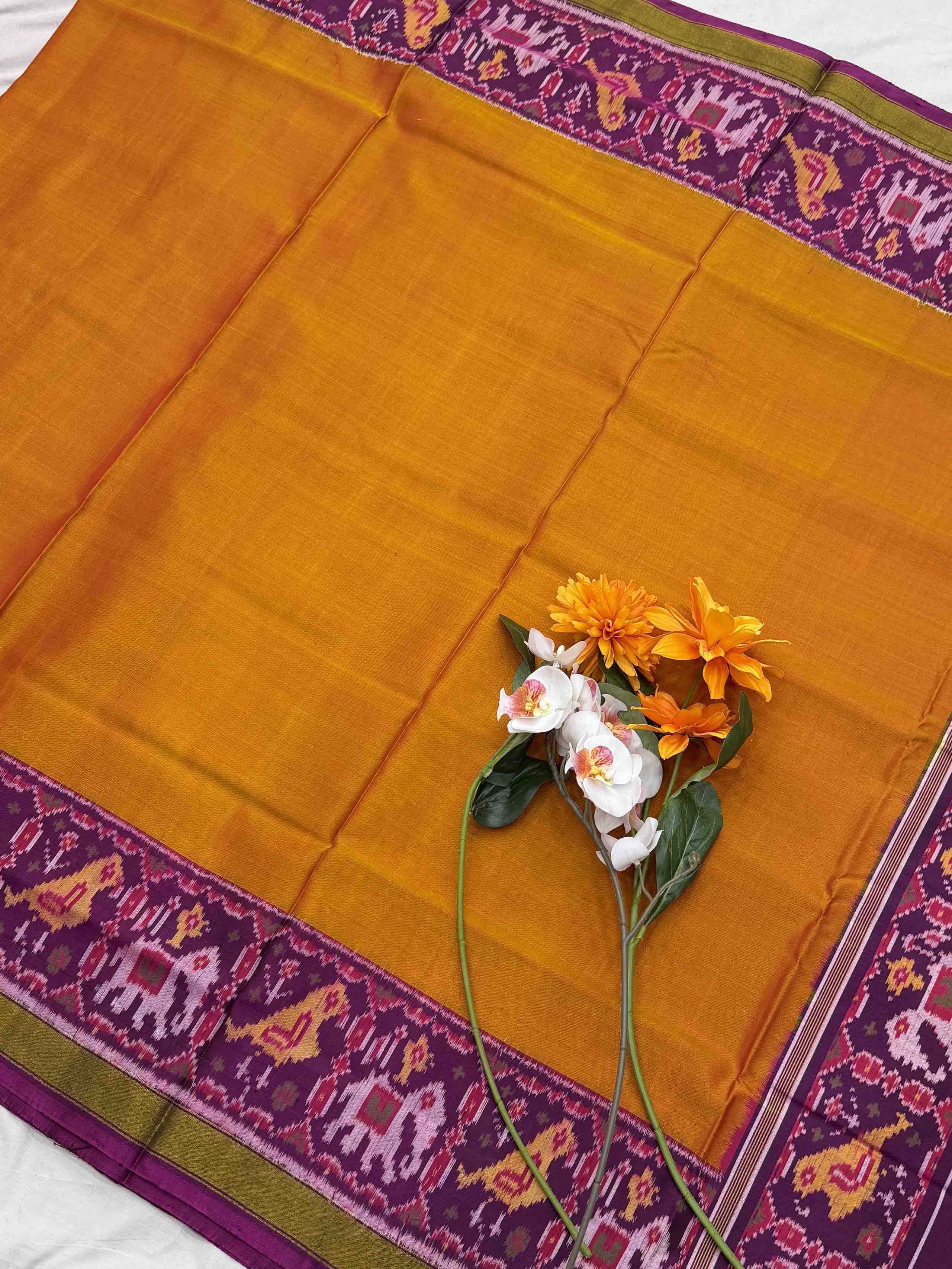 Magenta Narikunj Pallu & plain orange gala border Patola Saree