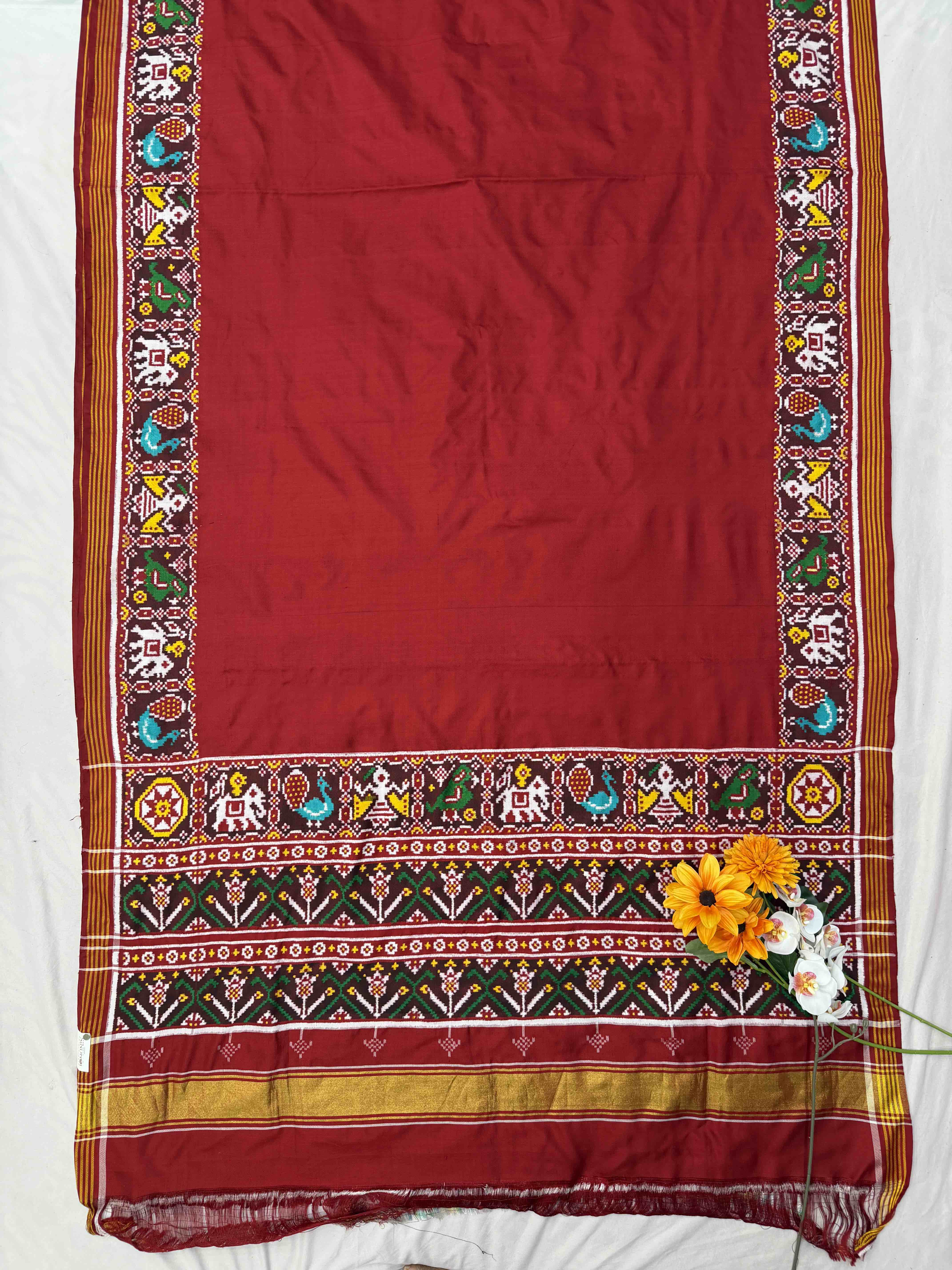 Red plain Patan Patola with narikunj border pallu